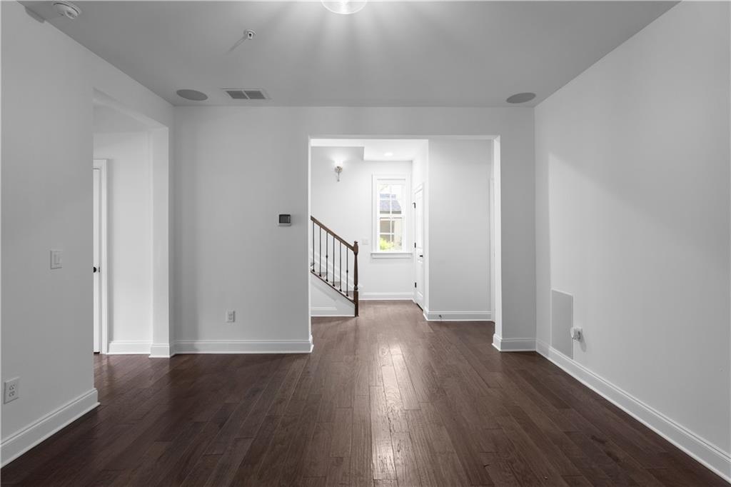 6408 Radiant Trace Atlanta, GA 30328 - Photo 34 of 40 a view of a hallway with wooden floor