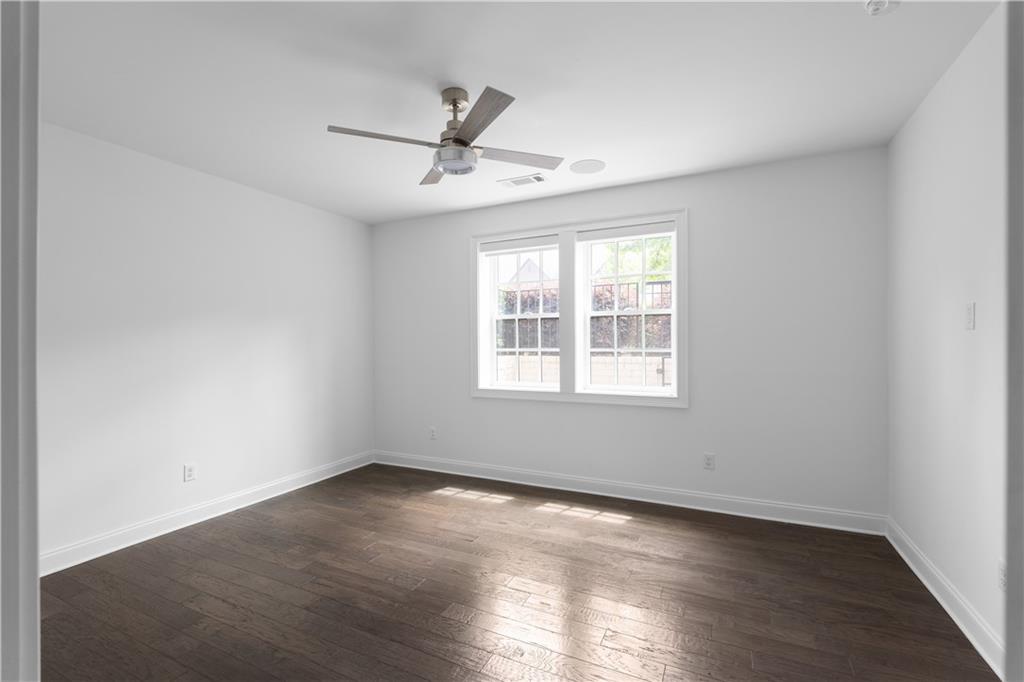 6408 Radiant Trace Atlanta, GA 30328 - Photo 36 of 40 an empty room with wooden floor fan and windows