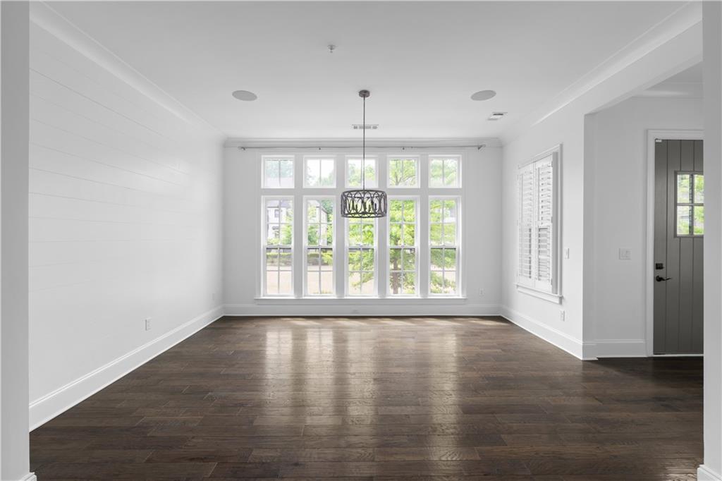6408 Radiant Trace Atlanta, GA 30328 - Photo 4 of 40 a view of an empty room with wooden floor and a window