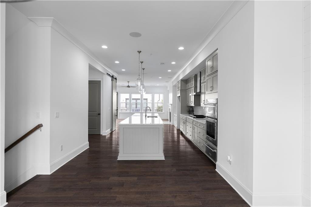 6408 Radiant Trace Atlanta, GA 30328 - Photo 5 of 40 a view of kitchen and hall with wooden floor