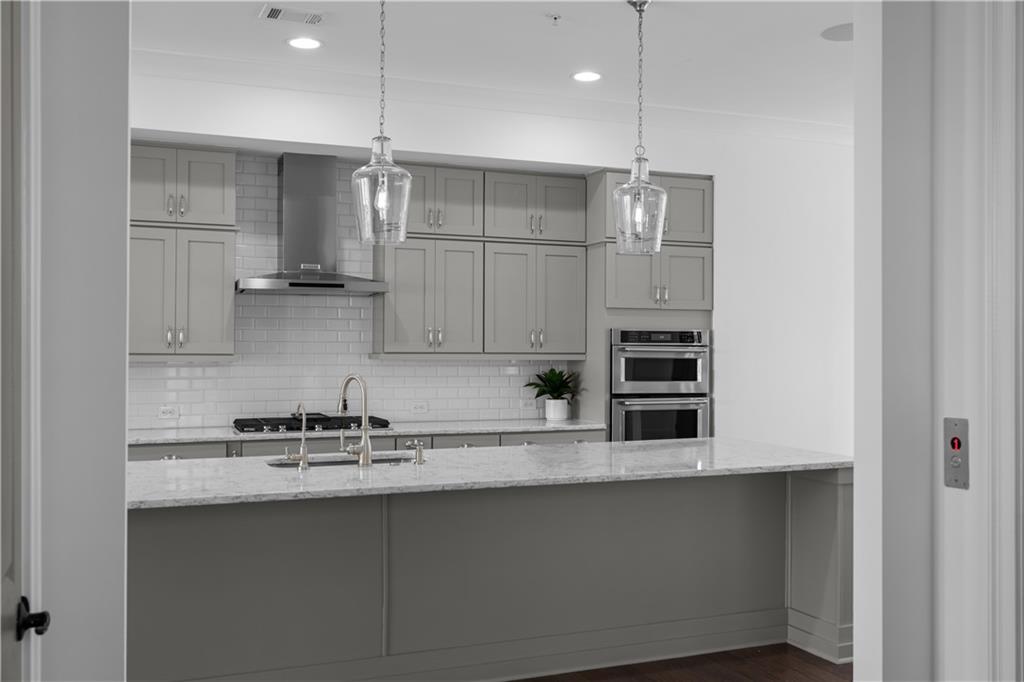 6408 Radiant Trace Atlanta, GA 30328 - Photo 6 of 40 a kitchen with a sink and stainless steel appliances