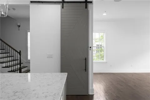an entryway with wooden floor and cabinet