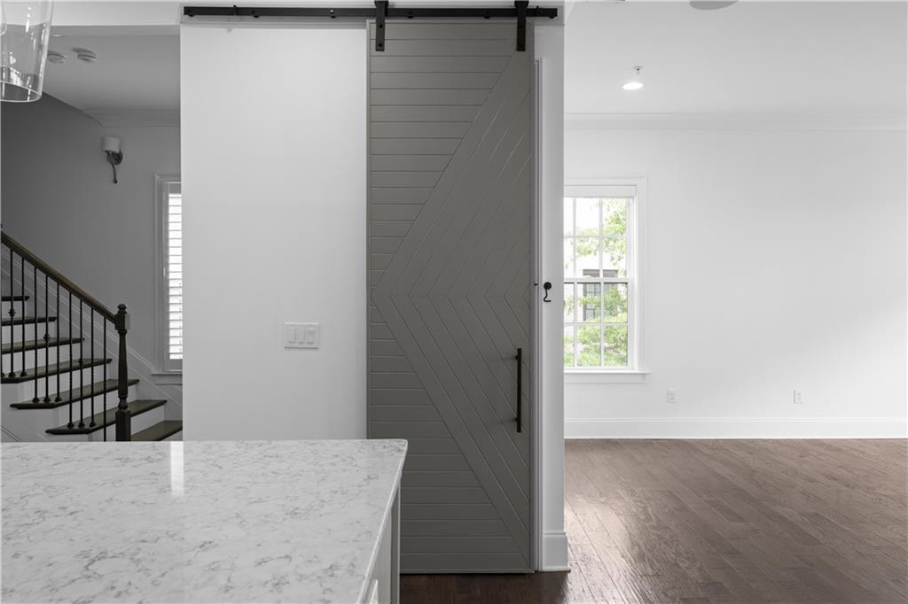6408 Radiant Trace Atlanta, GA 30328 - Photo 8 of 40 an entryway with wooden floor and cabinet
