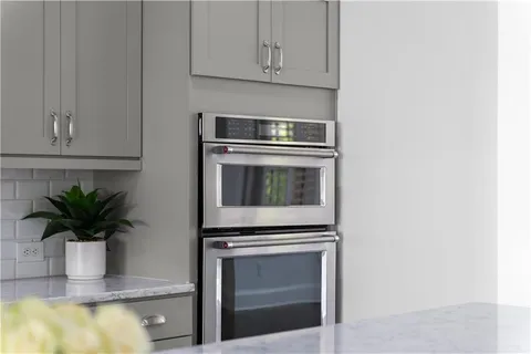 a kitchen with a potted plant on the counter and cabinets