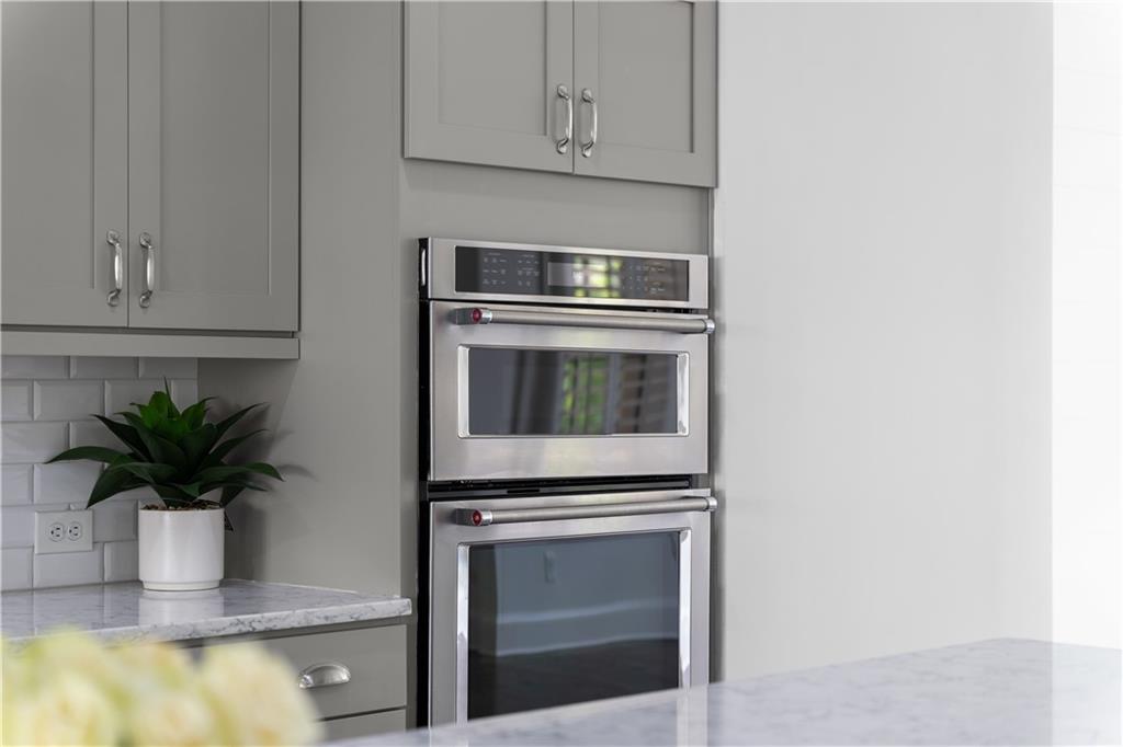 6408 Radiant Trace Atlanta, GA 30328 - Photo 10 of 40 a kitchen with a potted plant on the counter and cabinets