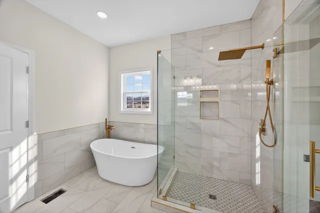a bathroom with a bathtub and shower