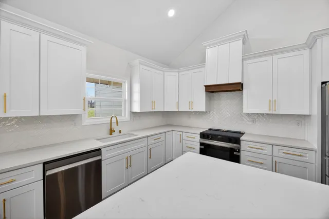 a kitchen with a sink stove and cabinets