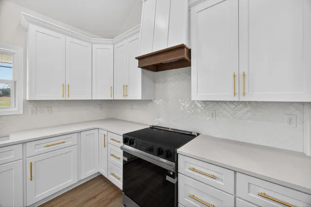 a kitchen with white cabinets stainless steel appliances and sink