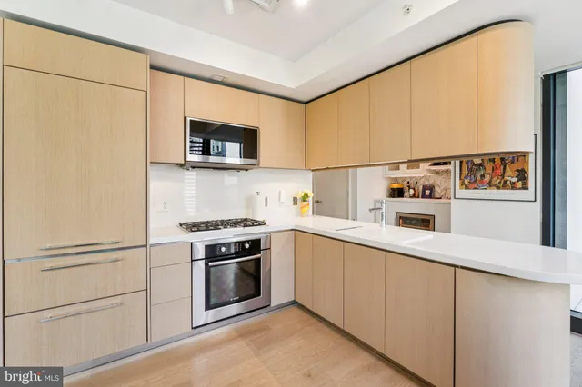 a kitchen with sink refrigerator and stove