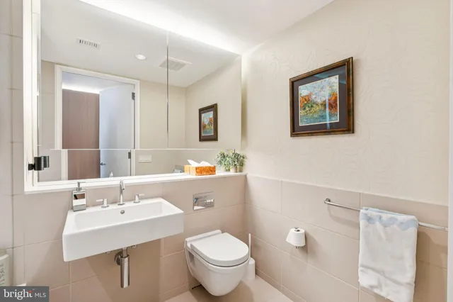 a bathroom with a sink mirror and a bathtub