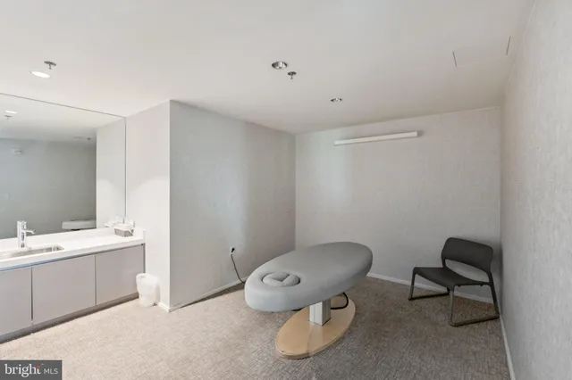 a view of swimming pool with outdoor seating and a garden