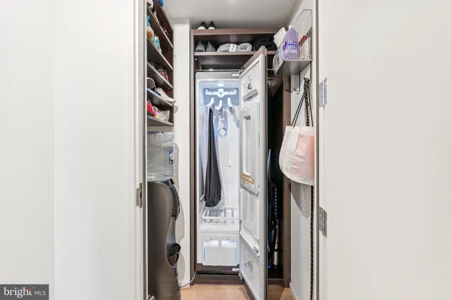 a view of walk in closet with clothes and shoes