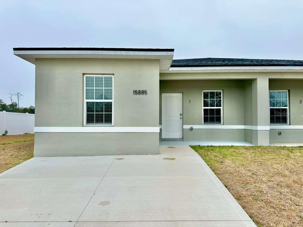 15885 Southwest 35th Court Road, Unit 1 Ocala, FL 34473 - Photo 2 of 27 front view of a house with a yard