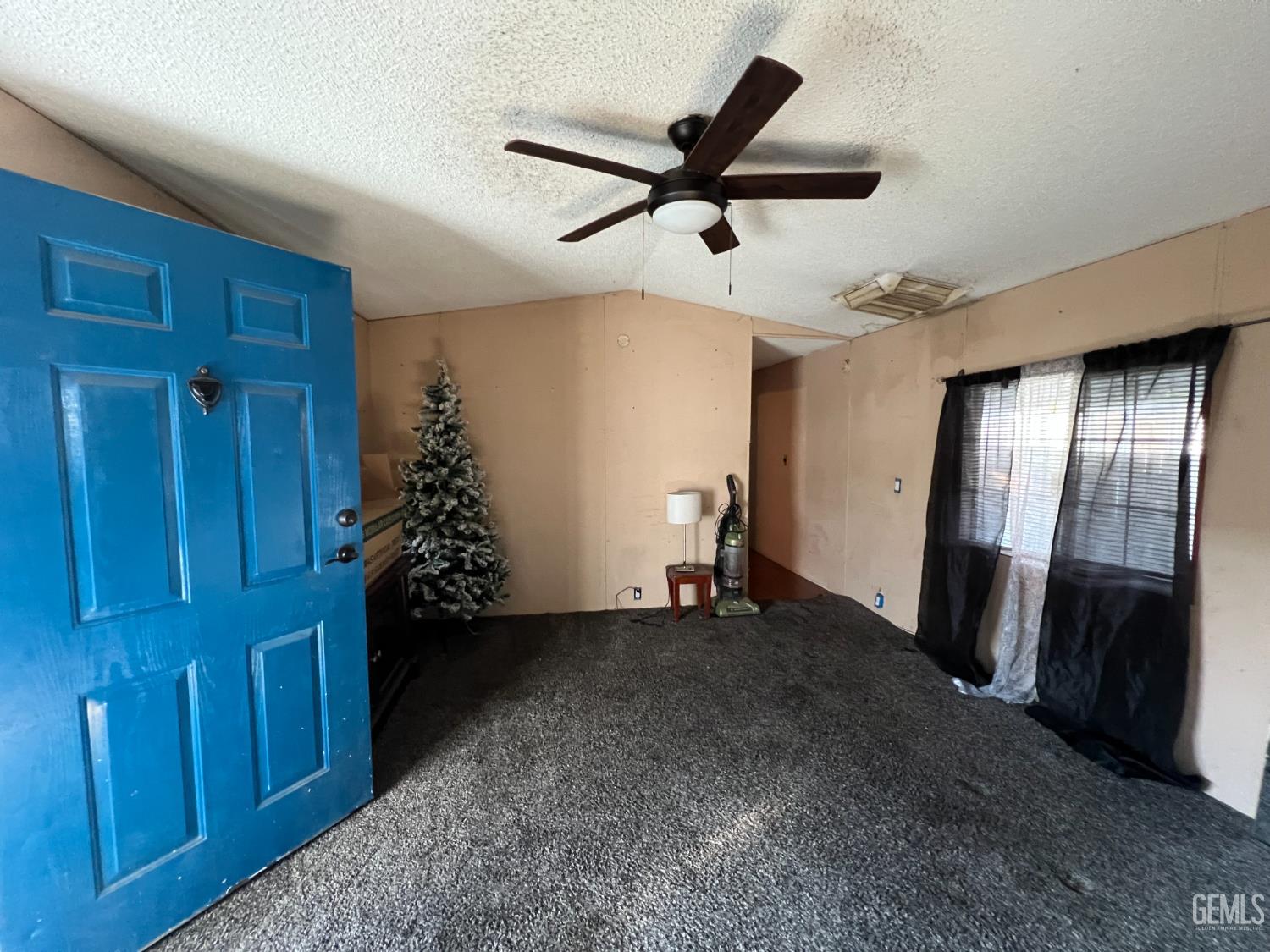 Undisclosed Address Bakersfield, CA 93309 - Photo 4 of 14 a view of a livingroom with a ceiling fan and wooden floor