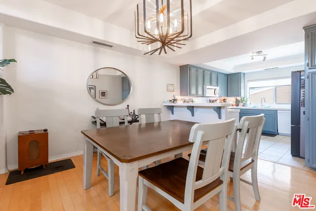 a kitchen with a table chairs sink and cabinets