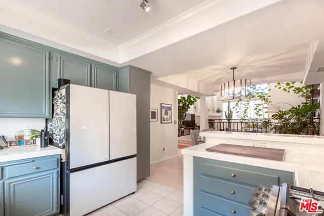a kitchen with a refrigerator a sink and cabinets