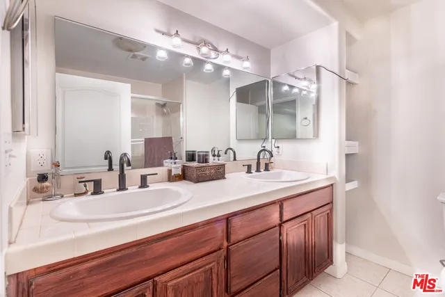 a bathroom with a sink double vanity and a mirror