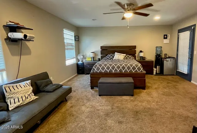 a bedroom with a bed window and couch