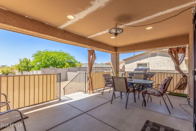 a view of a patio with a table and chairs