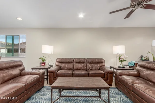 a living room with furniture a lamp and a window
