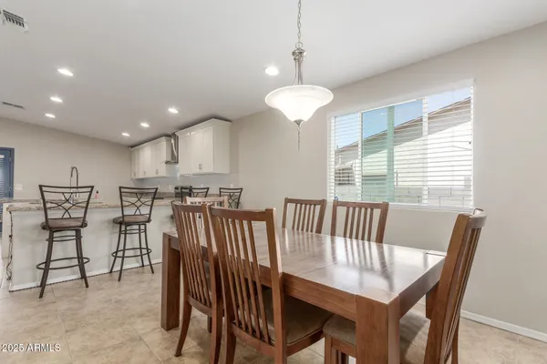 a view of a a dining room with furniture window and wooden floor