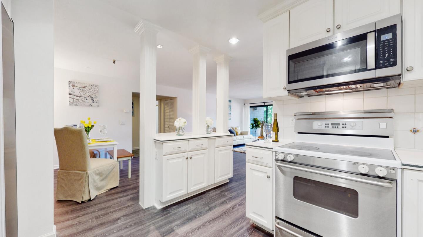 49 Showers Drive, Unit A134 Mountain View, CA 94040 - Photo 8 of 22 a kitchen with stainless steel appliances a stove microwave and white cabinets
