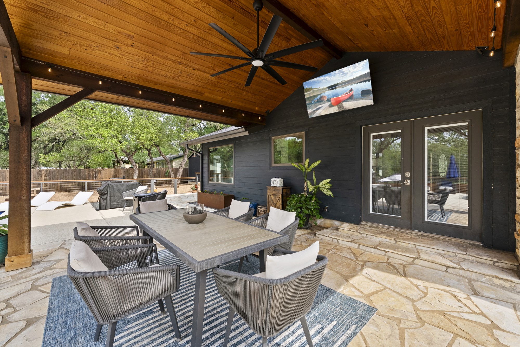 2802 Robin Road Manchaca, TX 78652 - Photo 2 of 40 Expansive covered patio featuring a wood-plank ceiling, ceiling fan, and string lighting