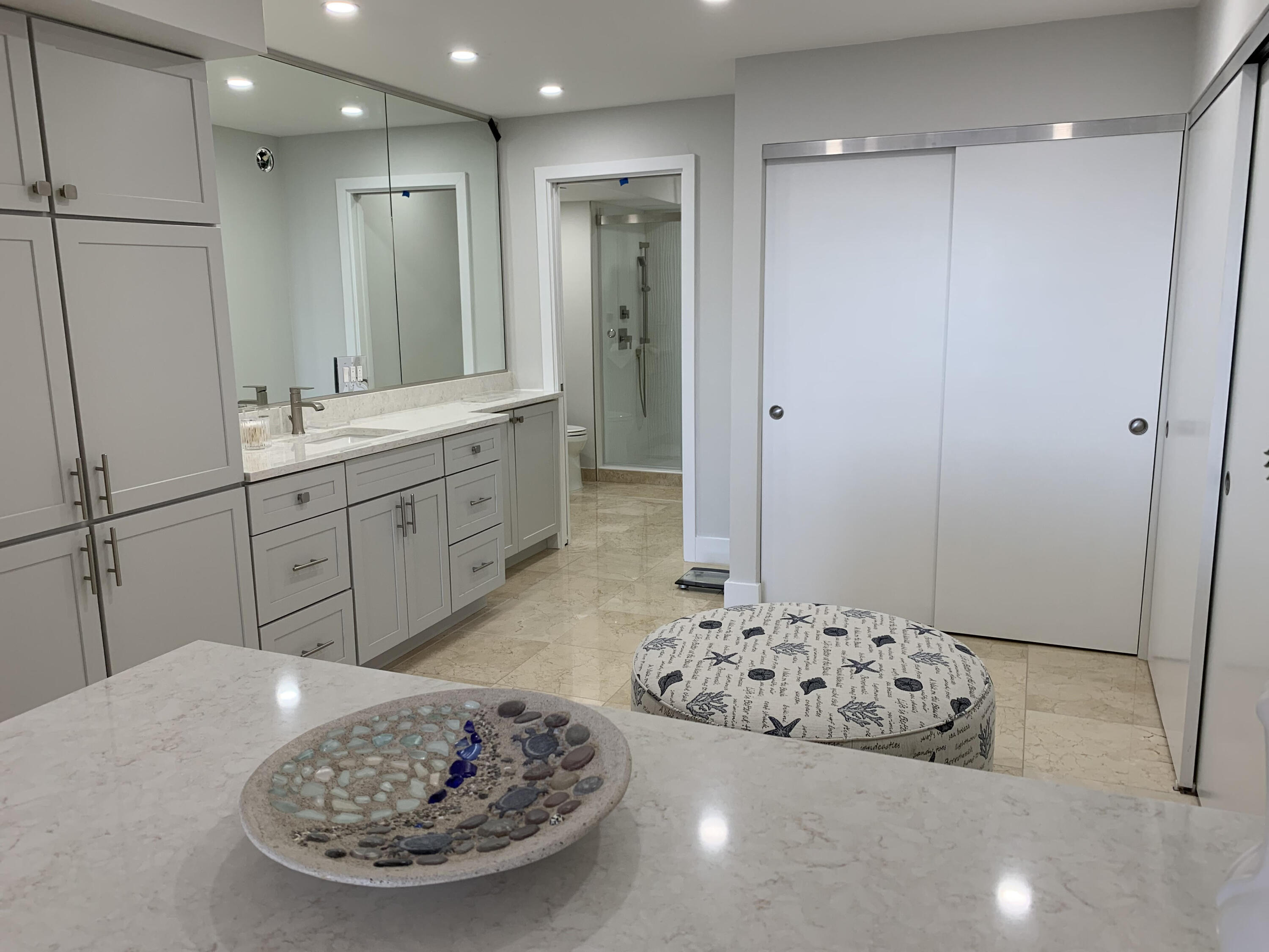 3115 South Ocean Boulevard, Unit 1002 Highland Beach, FL 33487 - Photo 12 of 37 a bathroom with a double vanity sink and a mirror