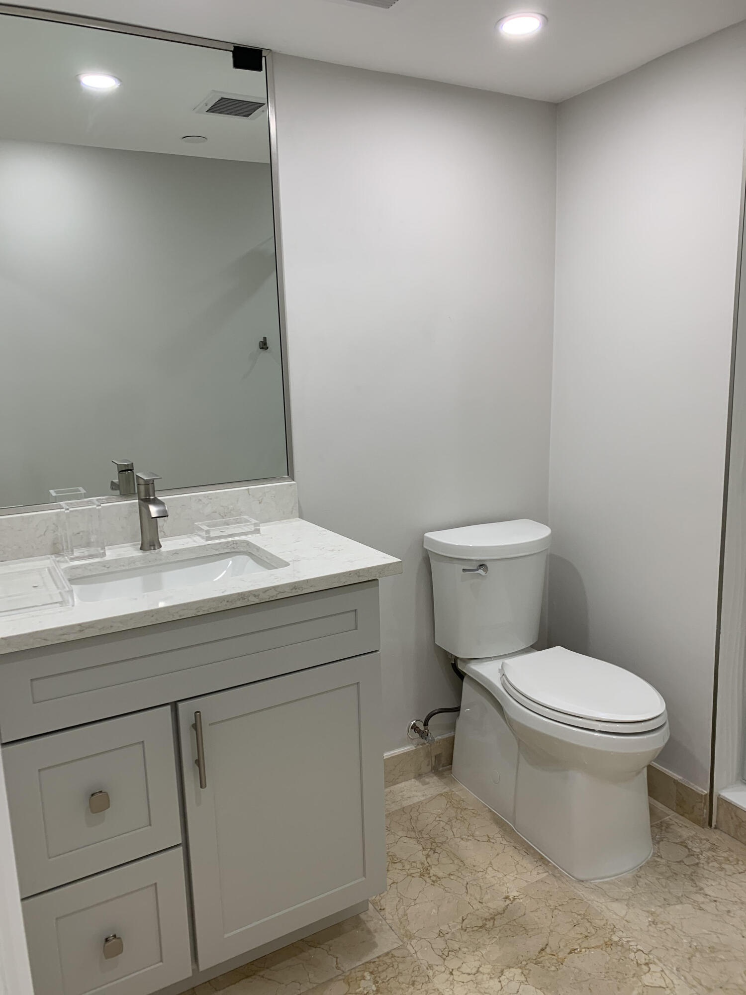 3115 South Ocean Boulevard, Unit 1002 Highland Beach, FL 33487 - Photo 13 of 37 a bathroom with a toilet sink and mirror