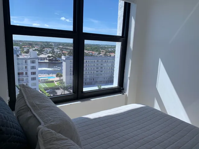 a living room with furniture and a floor to ceiling window