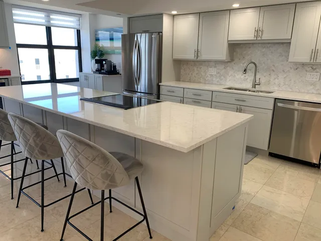 a kitchen with a table chairs sink and cabinets