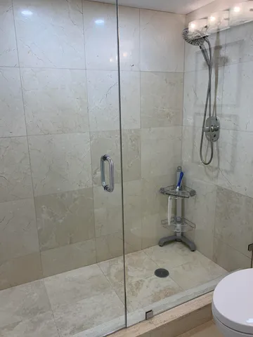 a bathroom with a shower and toilet