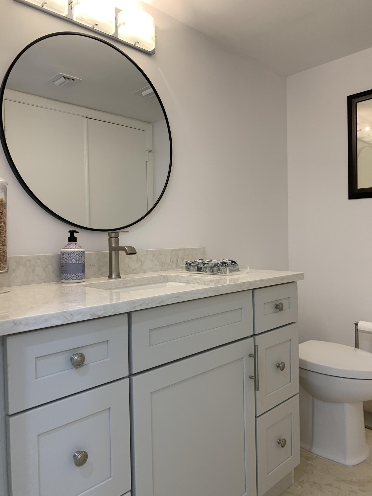3115 South Ocean Boulevard, Unit 1002 Highland Beach, FL 33487 - Photo 22 of 37 a bathroom with a sink and mirror