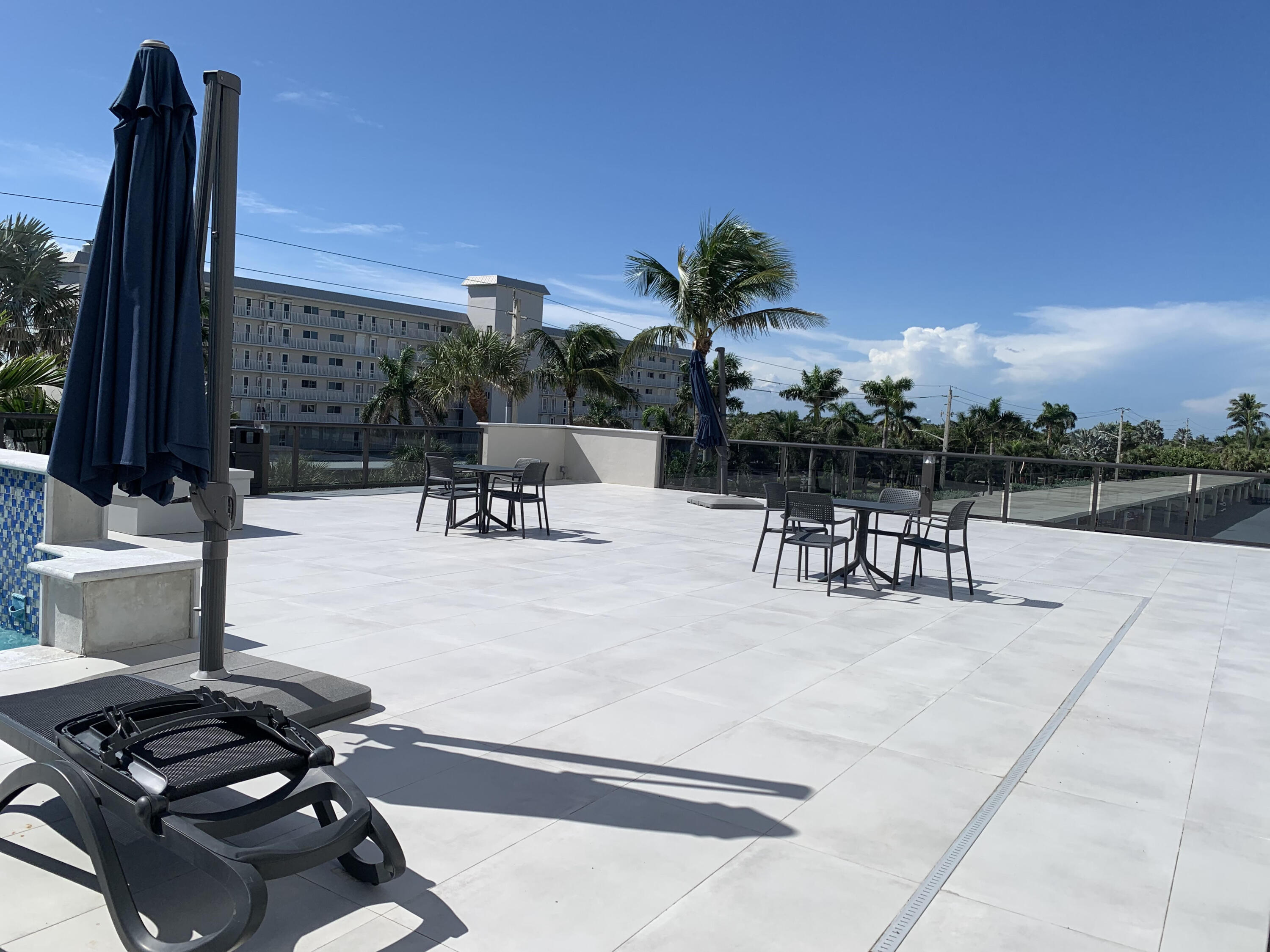 3115 South Ocean Boulevard, Unit 1002 Highland Beach, FL 33487 - Photo 25 of 37 a swimming pool with outdoor seating and city view