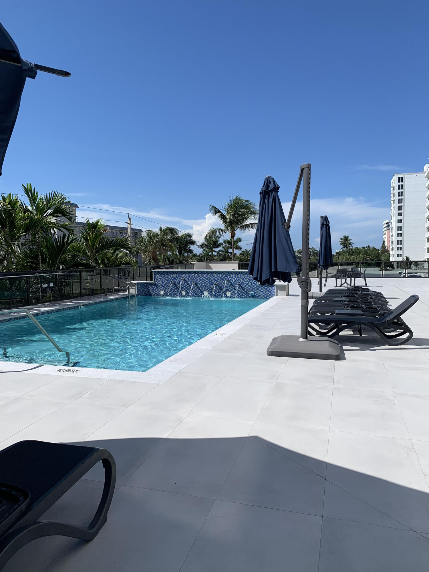 3115 South Ocean Boulevard, Unit 1002 Highland Beach, FL 33487 - Photo 26 of 37 a view of a swimming pool with a yard