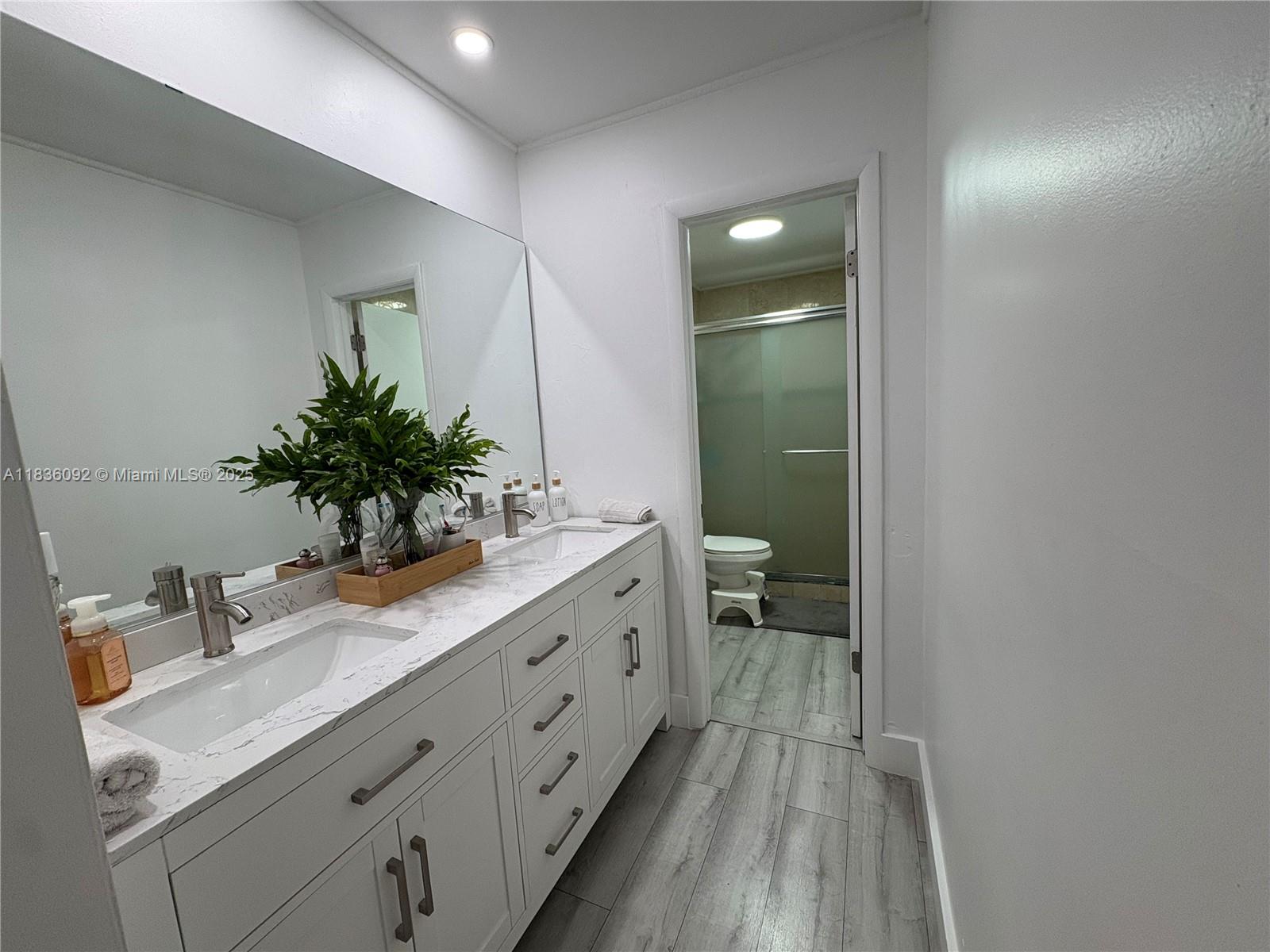 3320 Southwest 139th Avenue Miami, FL 33175 - Photo 11 of 23 a bathroom with a double vanity sink and mirror
