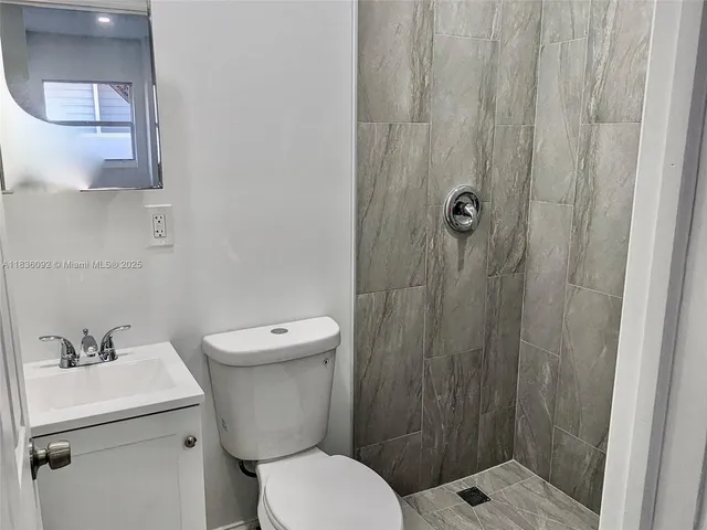 a bathroom with a toilet a sink and shower
