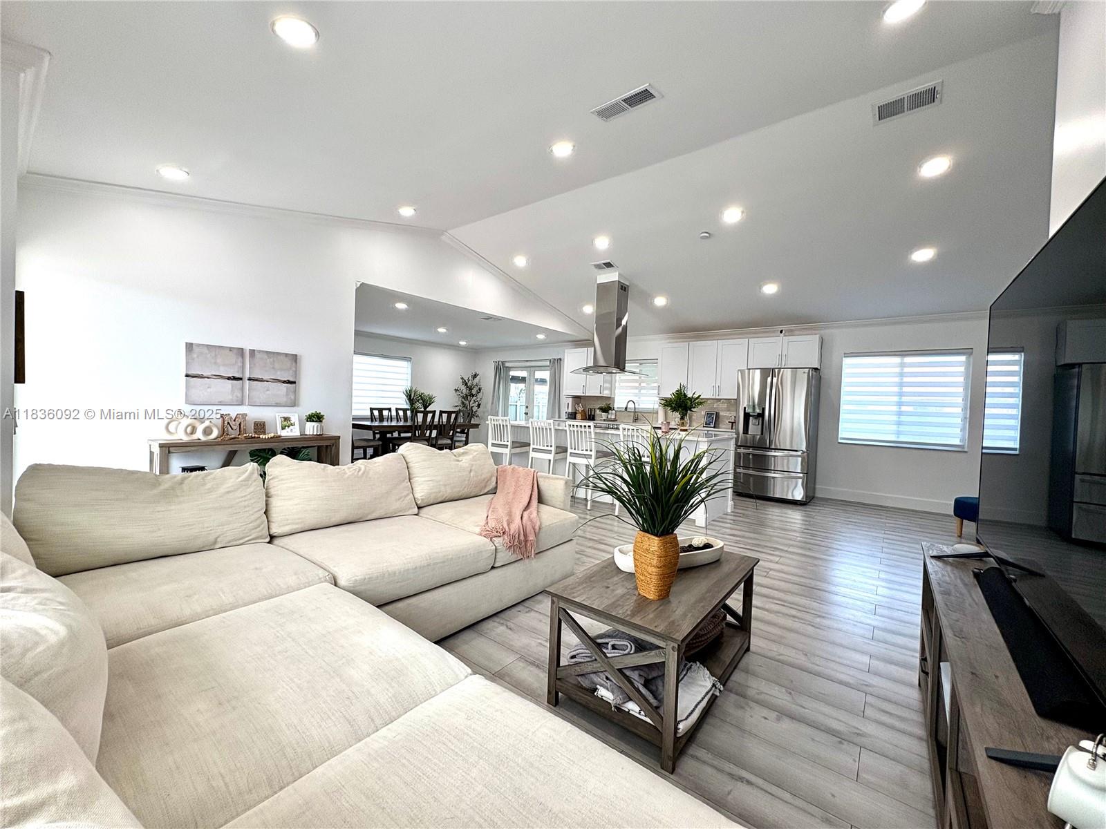 3320 Southwest 139th Avenue Miami, FL 33175 - Photo 8 of 23 a living room with furniture kitchen view and a wooden floor