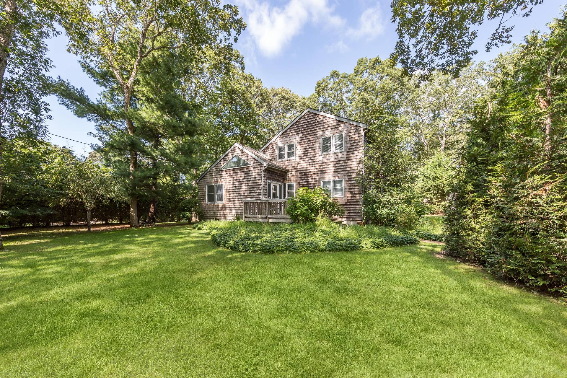 3 Spring Cl Lane East Hampton, NY 11937 - Photo 2 of 14 a backyard of a house with lots of green space and garden
