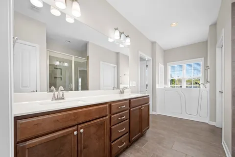 a bathroom with a sink double vanity and a shower