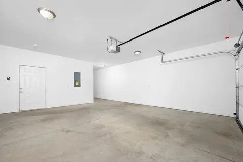 an empty room with a ceiling fan and window