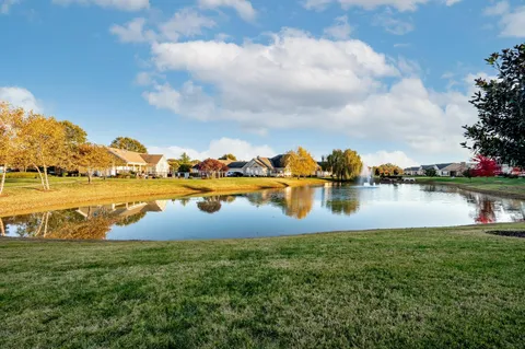 a view of a lake with houses in the back