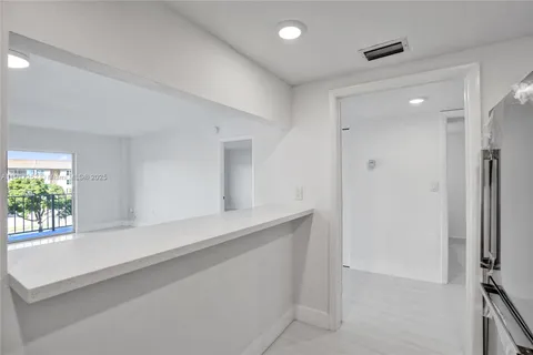 a kitchen with granite countertop cabinets stainless steel appliances and a sink