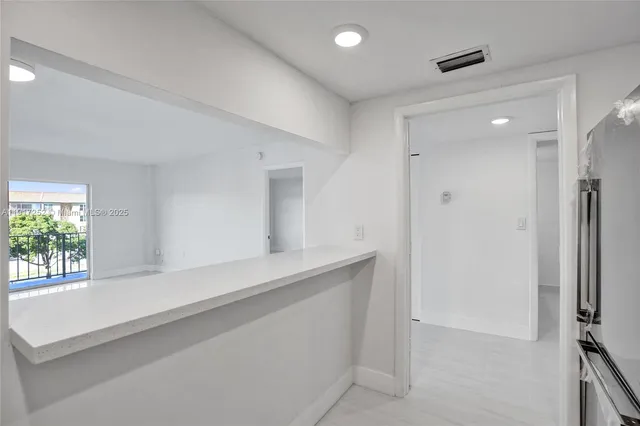 a kitchen with granite countertop cabinets stainless steel appliances and a sink