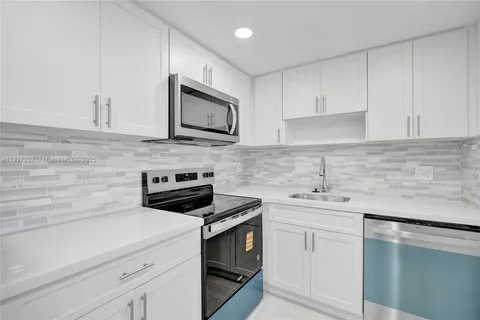 a kitchen with appliances and cabinets