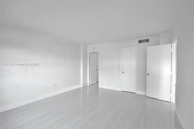 a bathroom with a bathtub shower sink vanity and toilet