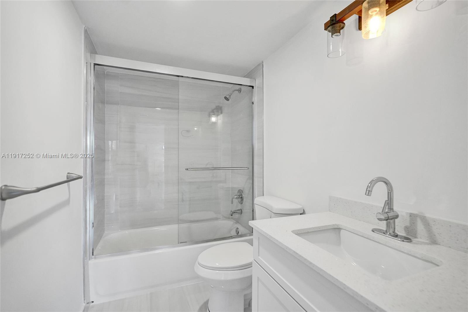 4164 Inverrary Drive, Unit 305 Lauderhill, FL 33319 - Photo 24 of 40 a bathroom with a bathtub shower sink vanity and toilet