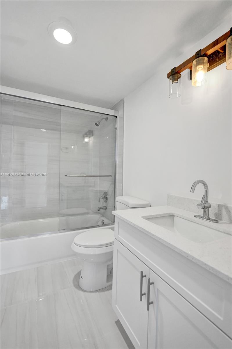 4164 Inverrary Drive, Unit 305 Lauderhill, FL 33319 - Photo 25 of 40 a bathroom with a sink a toilet and shower