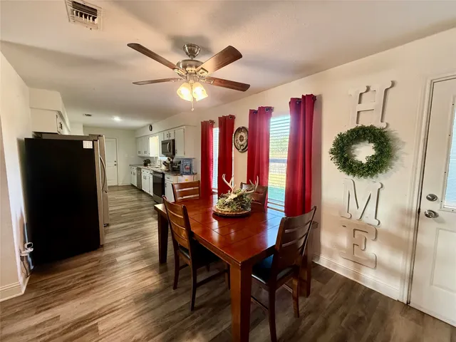 a view of a dining room with furniture and a chandelier