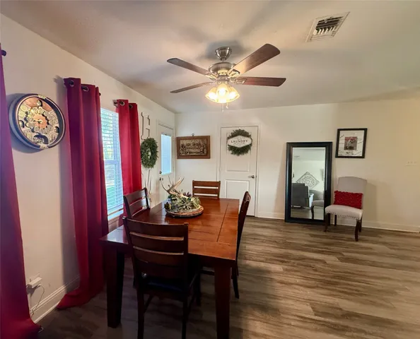 a view of a dining room with furniture and wooden floor